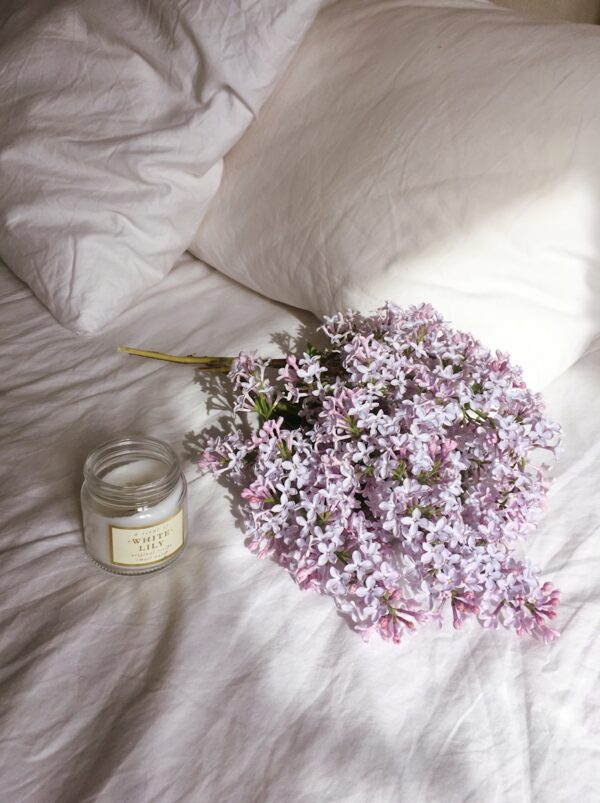 purple flower bouquet on white textile